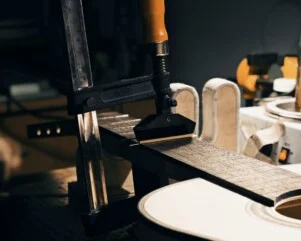 pressing frets on guitar neck